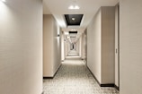 white and black hallway with lights turned on in the middle