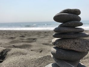 stack of stones on beach during daytime
