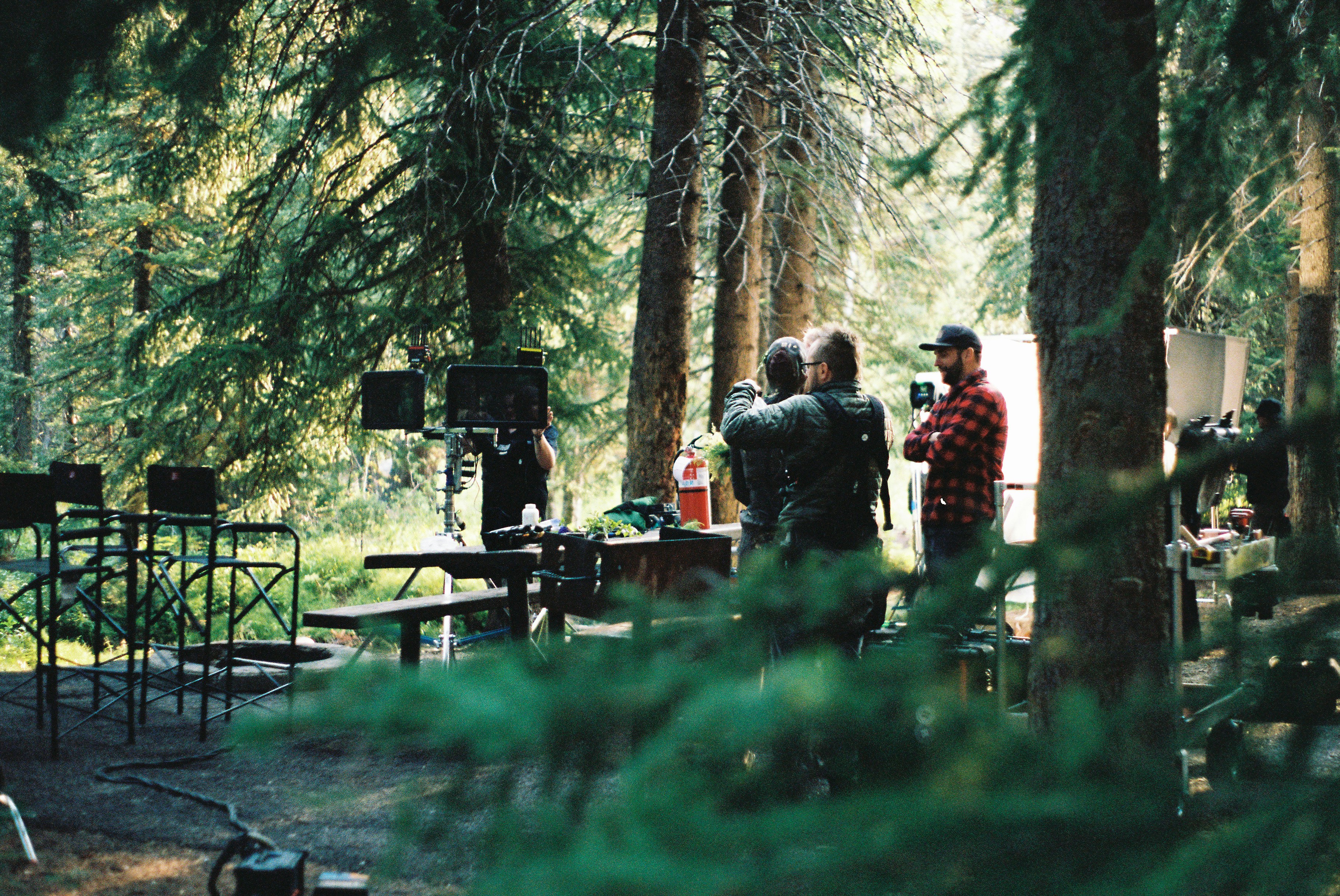 a group of people standing around a forest