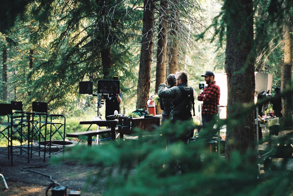 a group of people standing around a forest