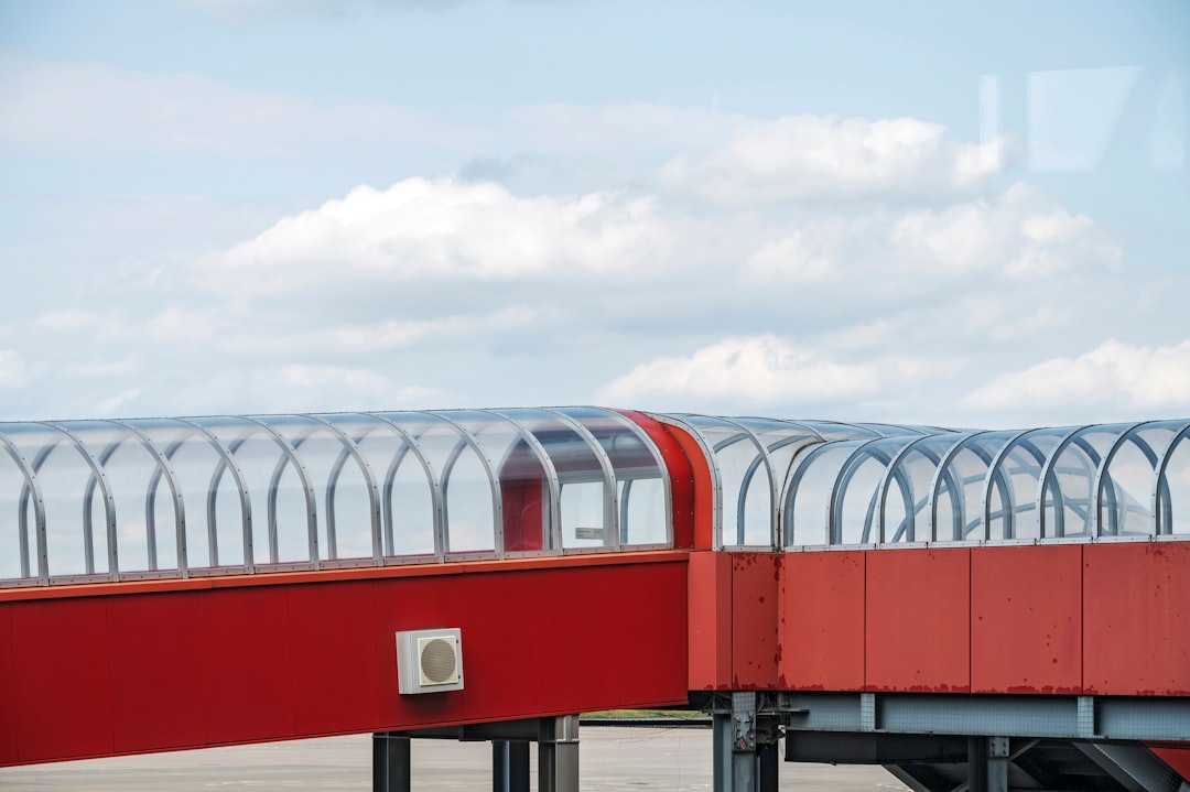 red and white building under white clouds during daytime