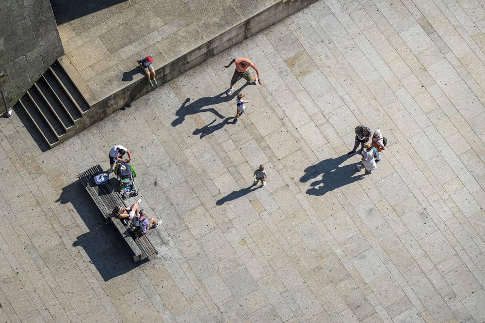 people playing basketball on gray concrete pavement during daytime