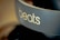 A close-up view of a pair of headphones featuring the brand name 'beats' prominently displayed on the side in light-colored text. The background is blurred, highlighting the focus on the branding.
