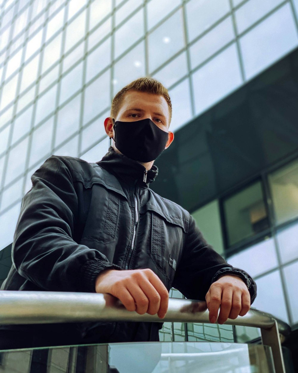 man in black leather jacket wearing black sunglasses