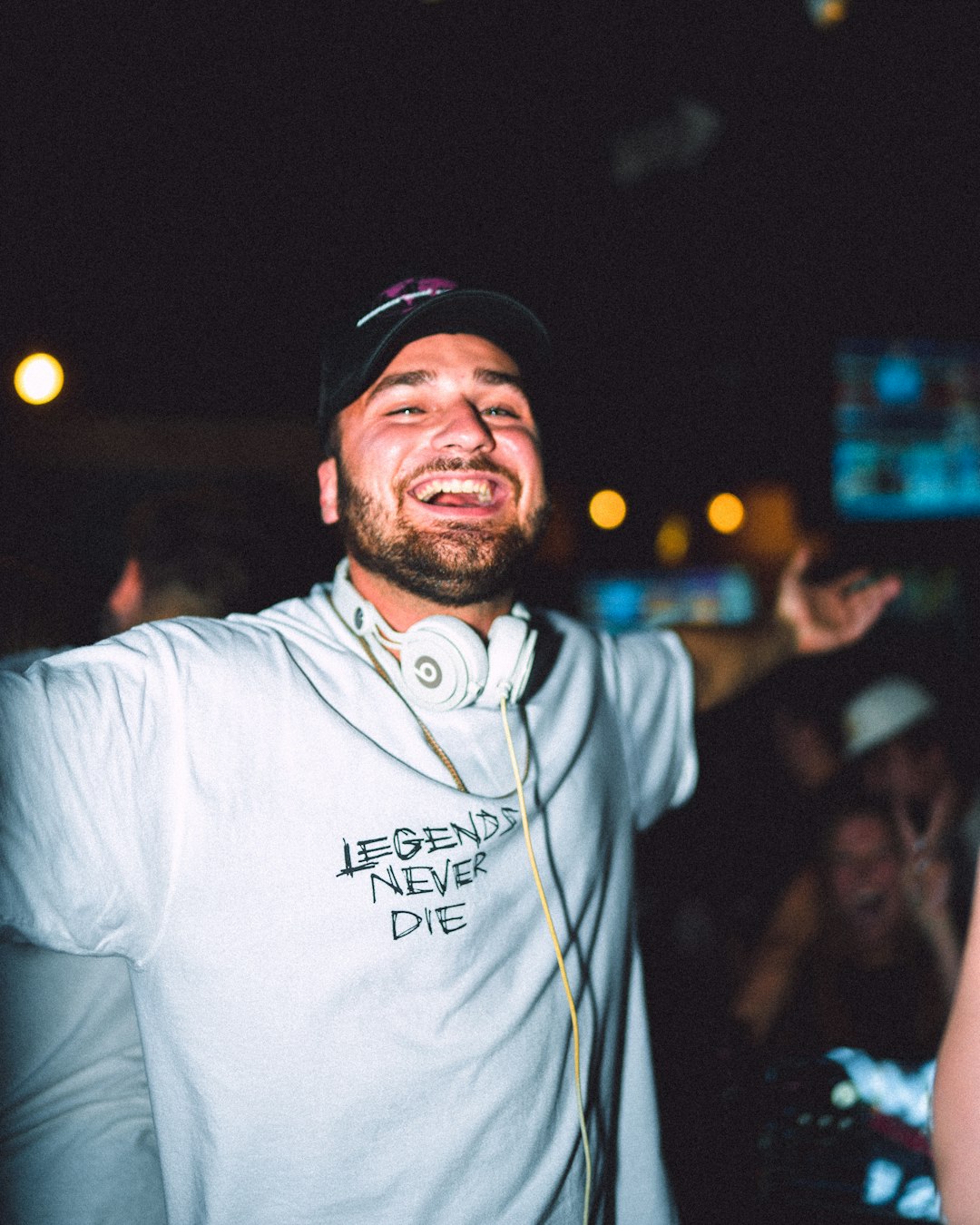 man in white crew neck t-shirt wearing black cap