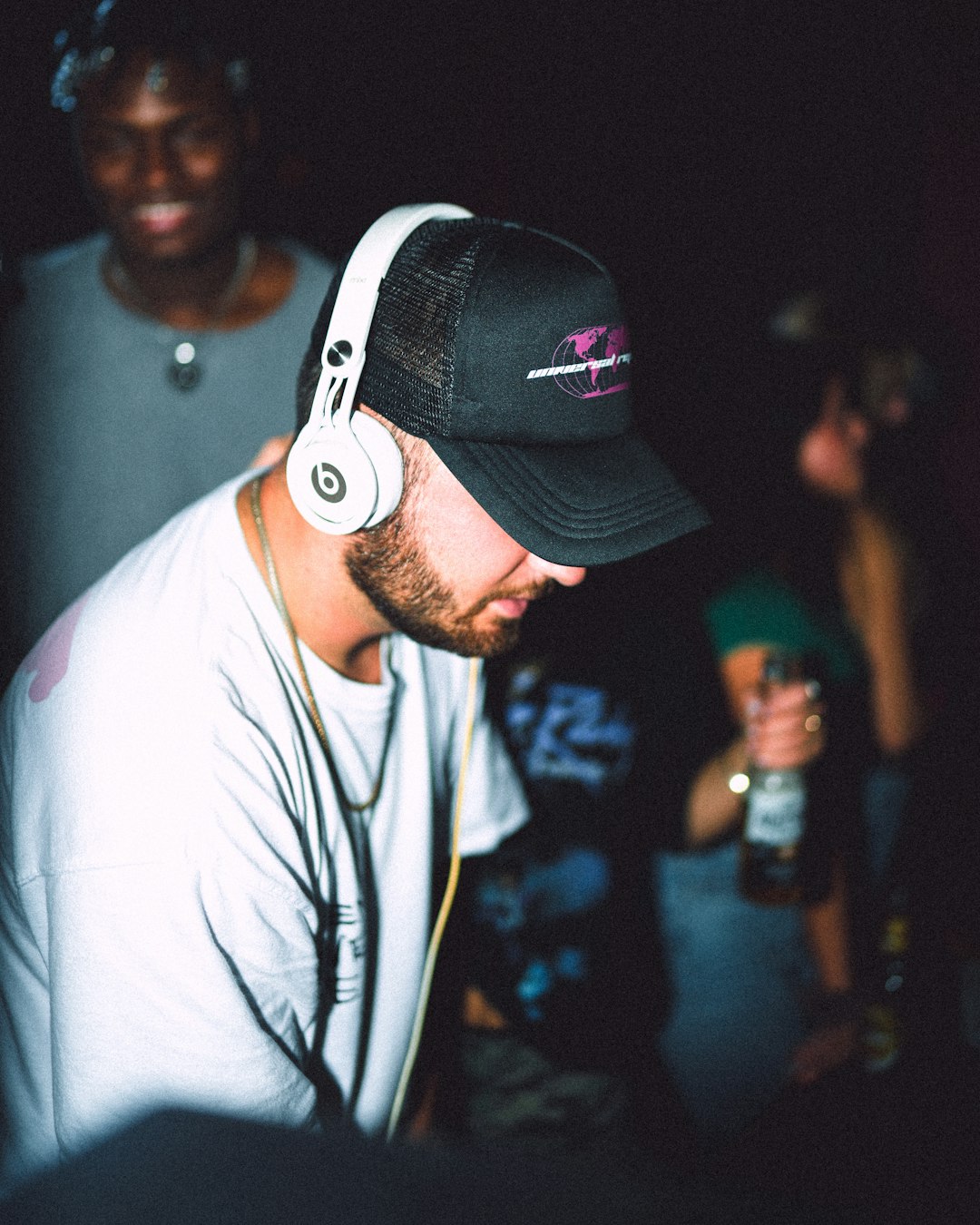 man in white crew neck t-shirt wearing black and white cap