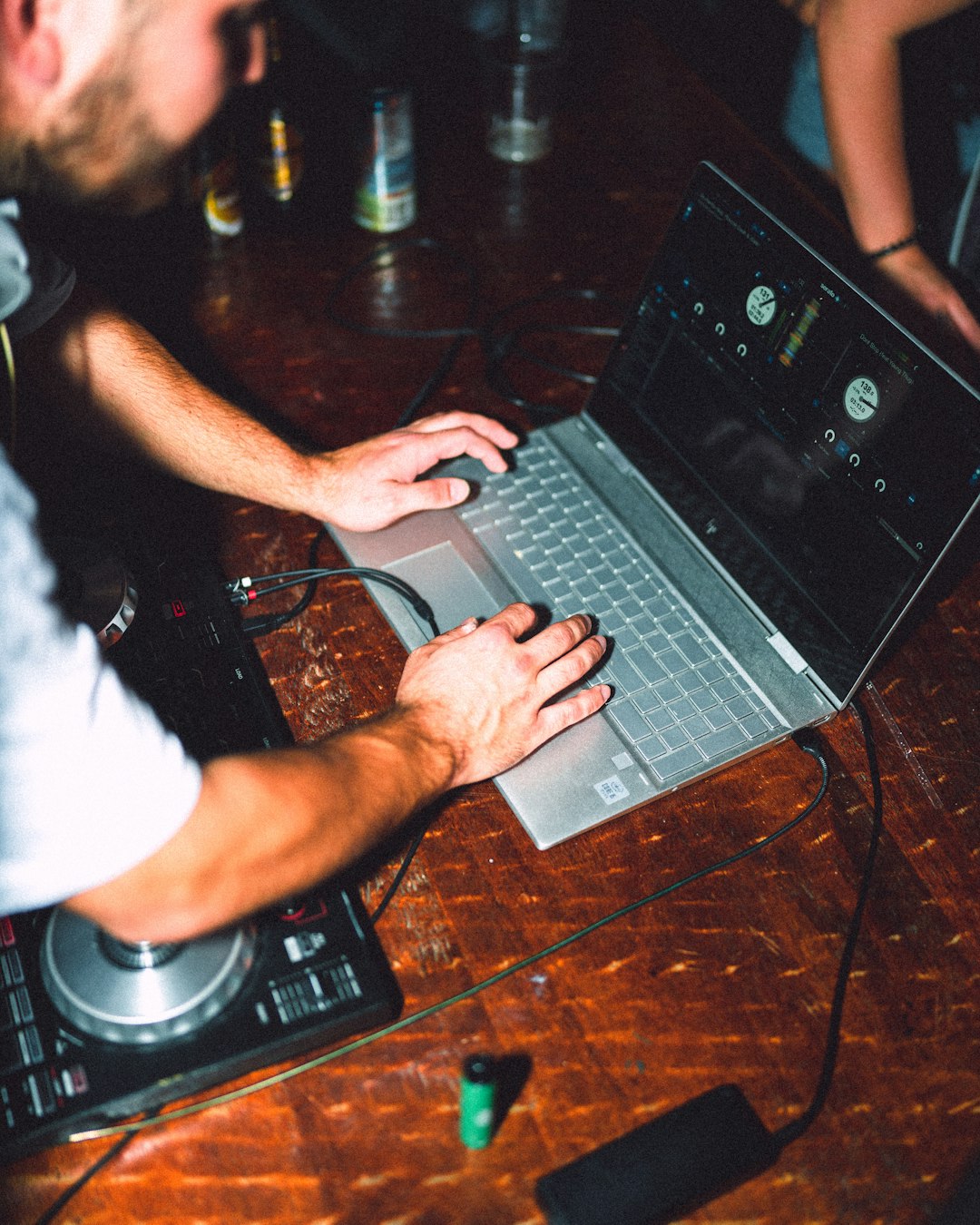 person in white shirt using gray laptop computer