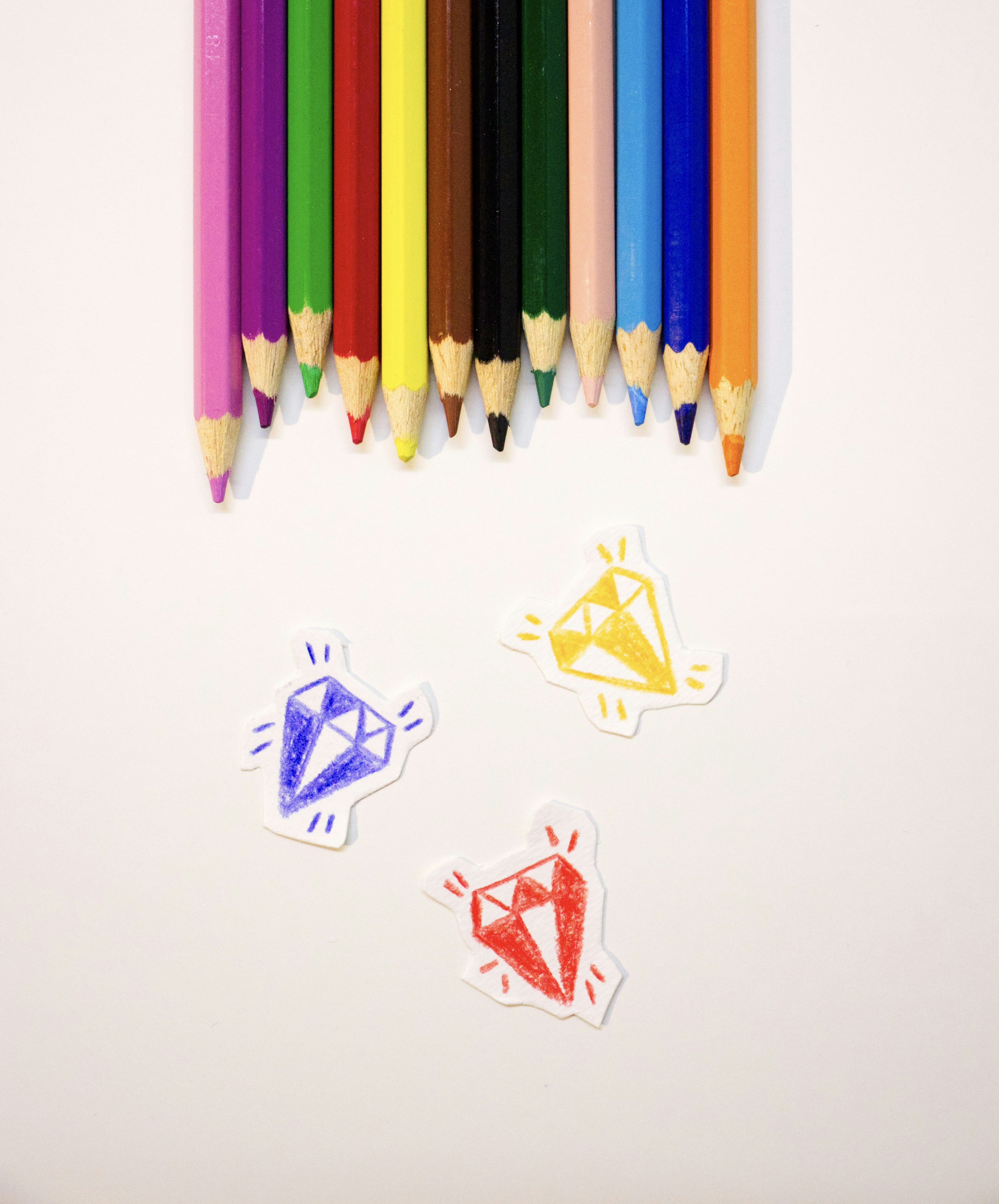 Purple, blue, and yellow colored pencils