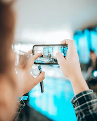 Vertical video frame displayed on a smartphone held by a creative professional.