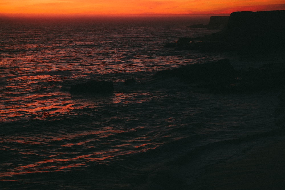 body of water during sunset