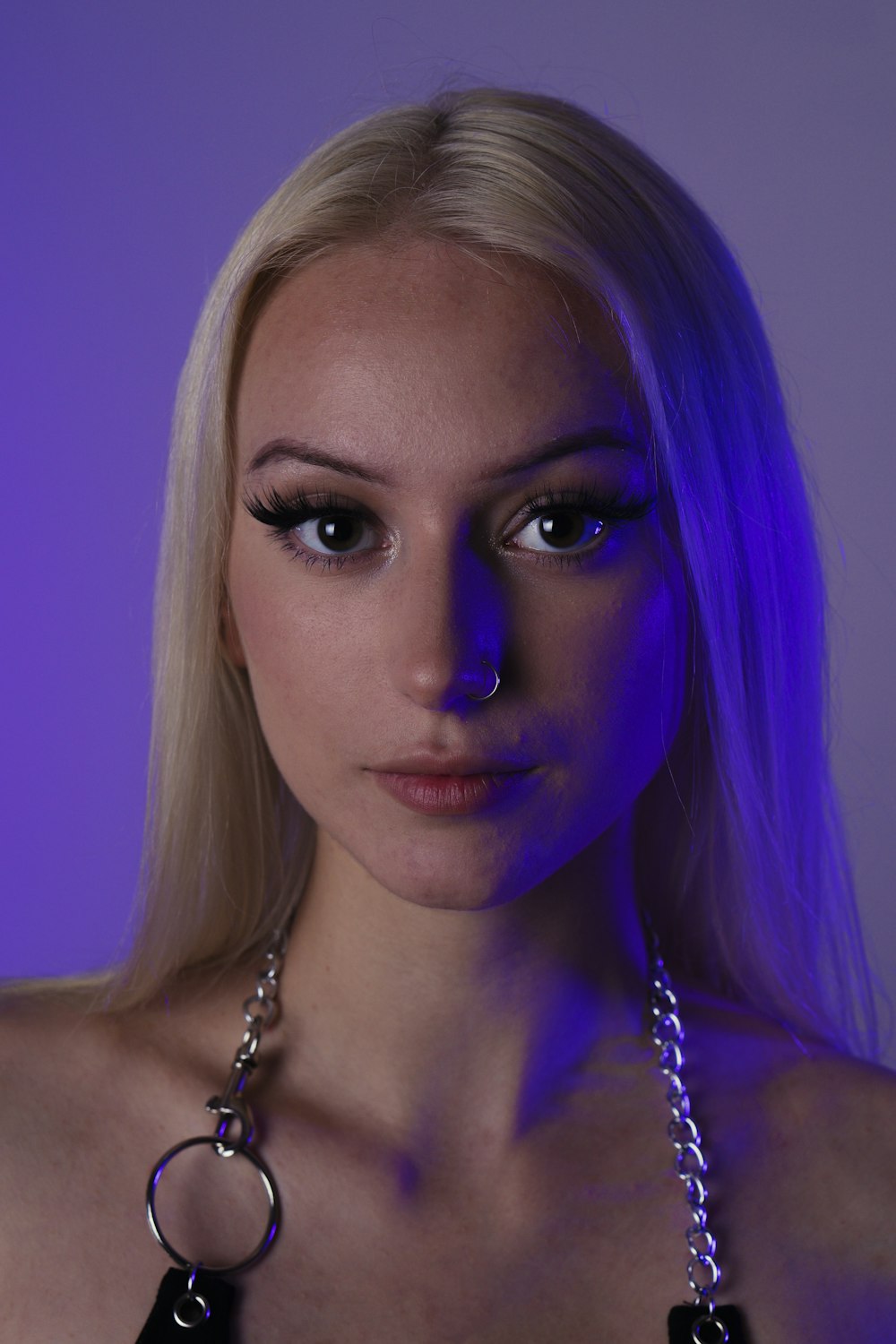 woman with purple hair wearing silver necklace