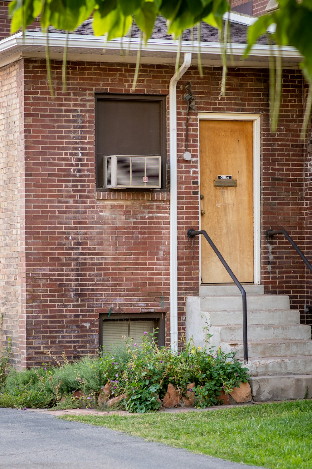 brown brick building with black metal railings