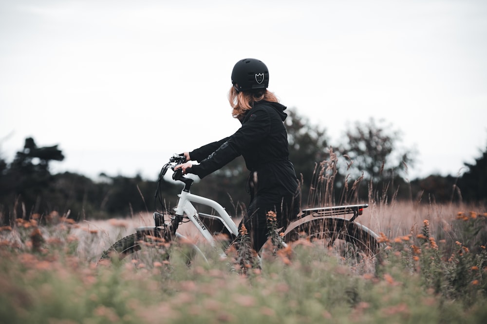 man in black jacket riding white motorcycle during daytime