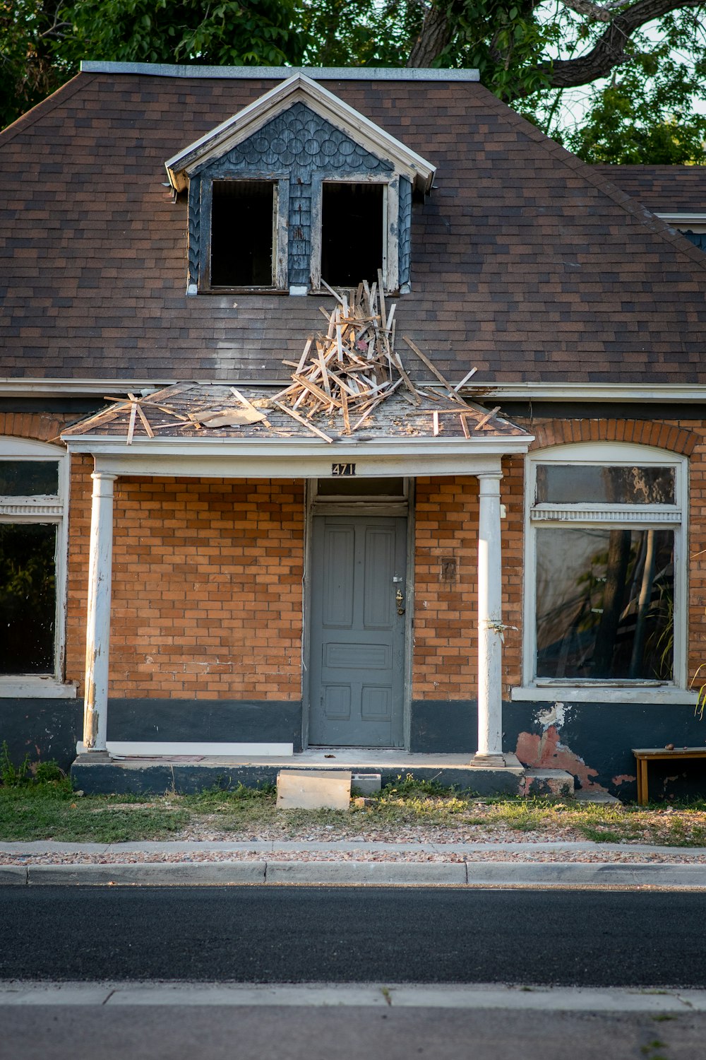 brown brick house with white wooden framed glass window