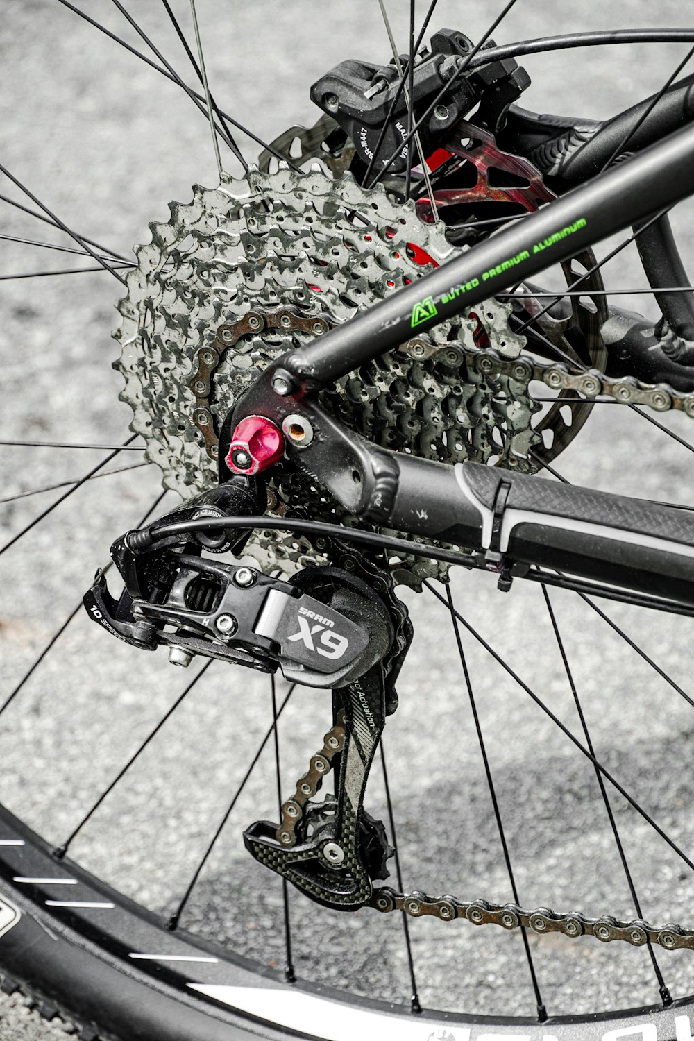 black bicycle wheel with chain link fence