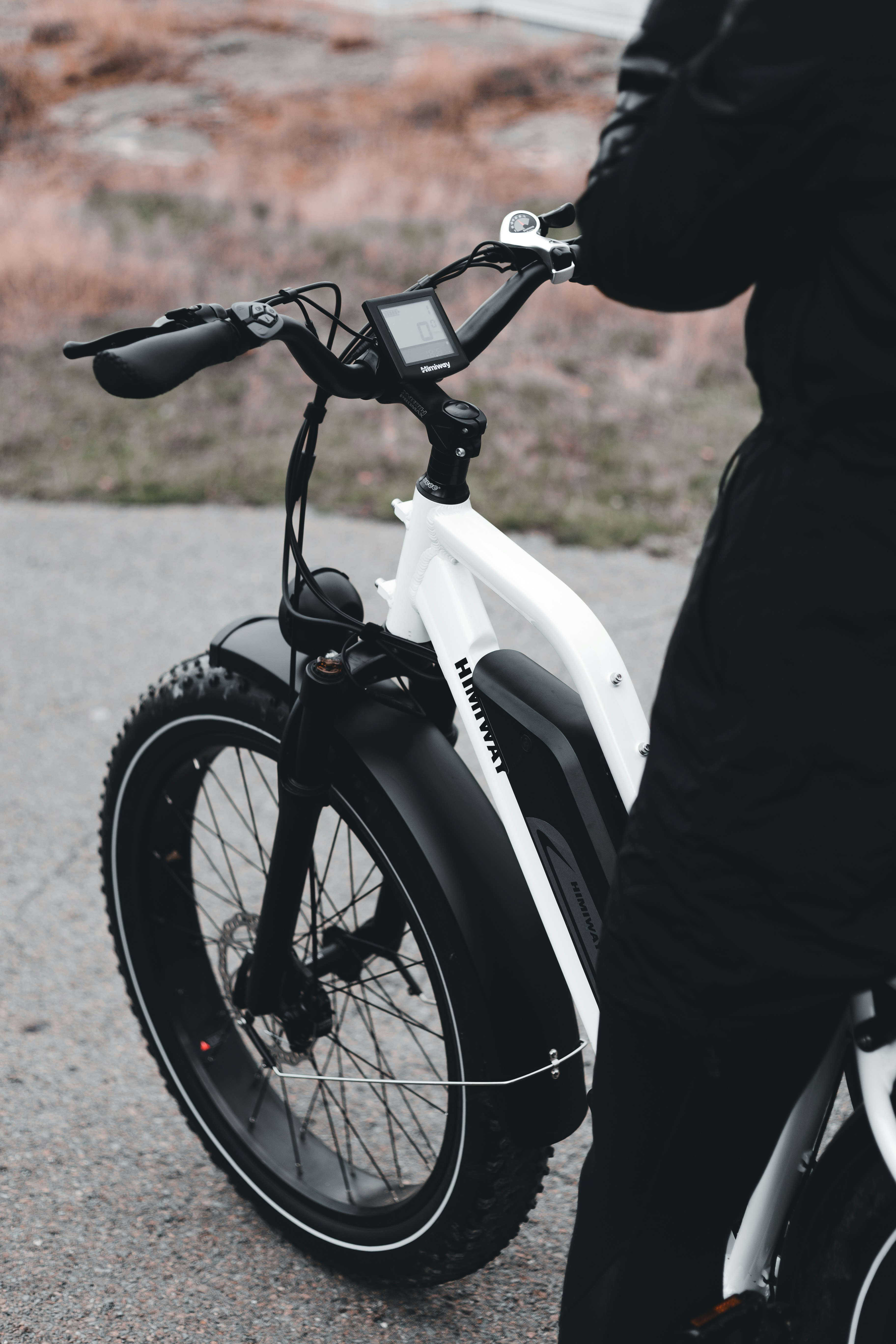 person in black jacket riding white motorcycle