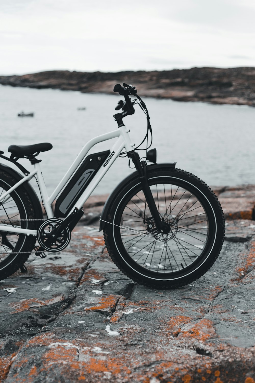 Bicicleta blanca y negra sobre piso de concreto marrón y gris