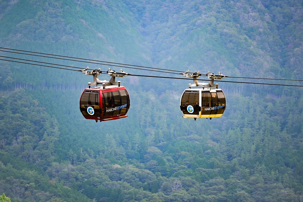 Hakone-Yumoto — Owakudani ropeway gondolas crossing above the volcanic valley near the gateway town