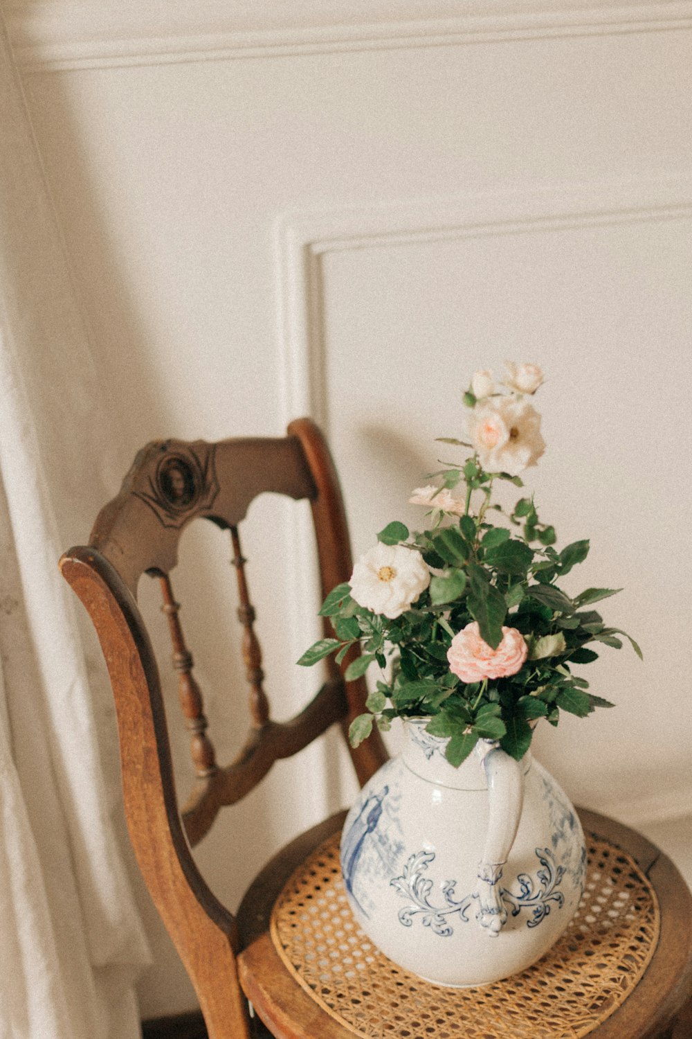 white and pink flower on white ceramic vase