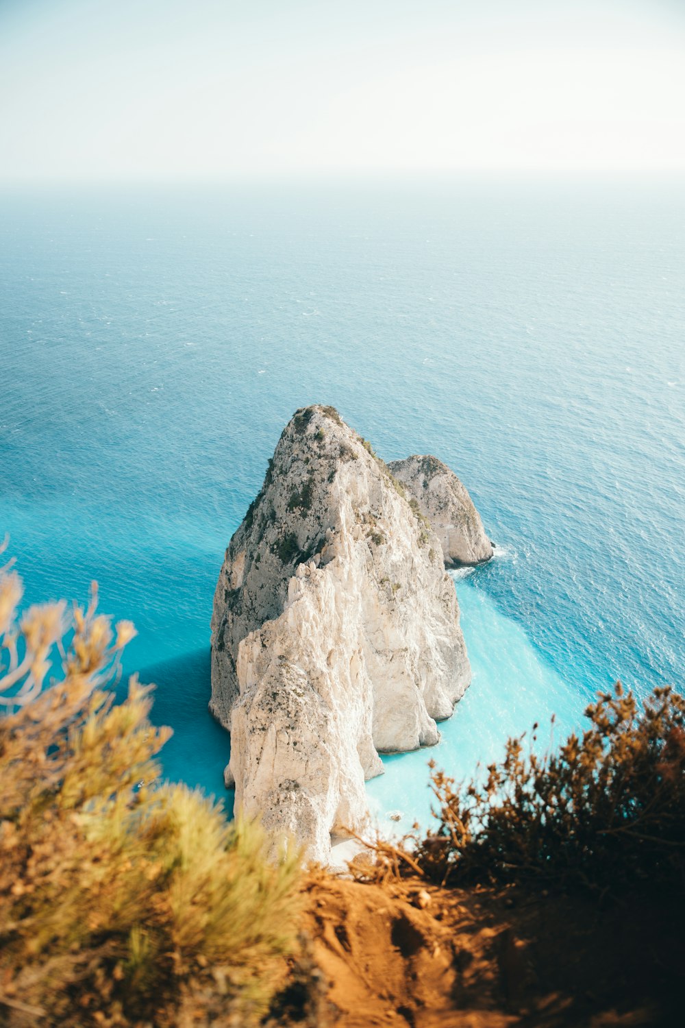 brown rock formation near blue sea during daytime