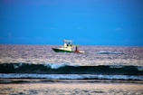 Modern motorboat speeding across a bright blue sea under clear skies