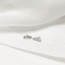Close-up of delicate rhodium plated earrings with sparkling CZ stones, perfect for everyday wear.