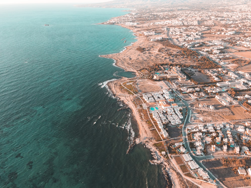 aerial view of city buildings near body of water during daytime