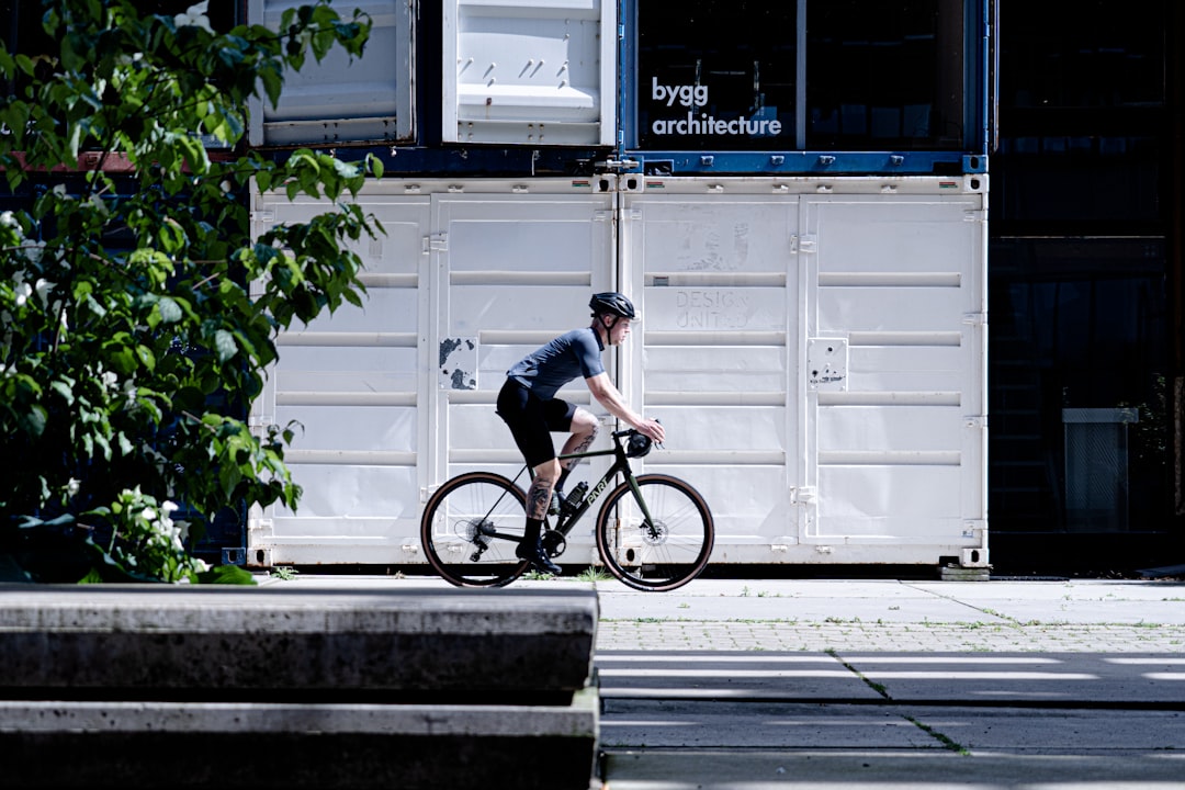 man in black t-shirt riding bicycle during daytime