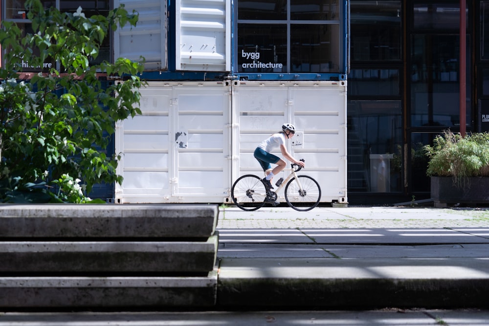 man in blue shirt riding bicycle on gray concrete stairs during daytime