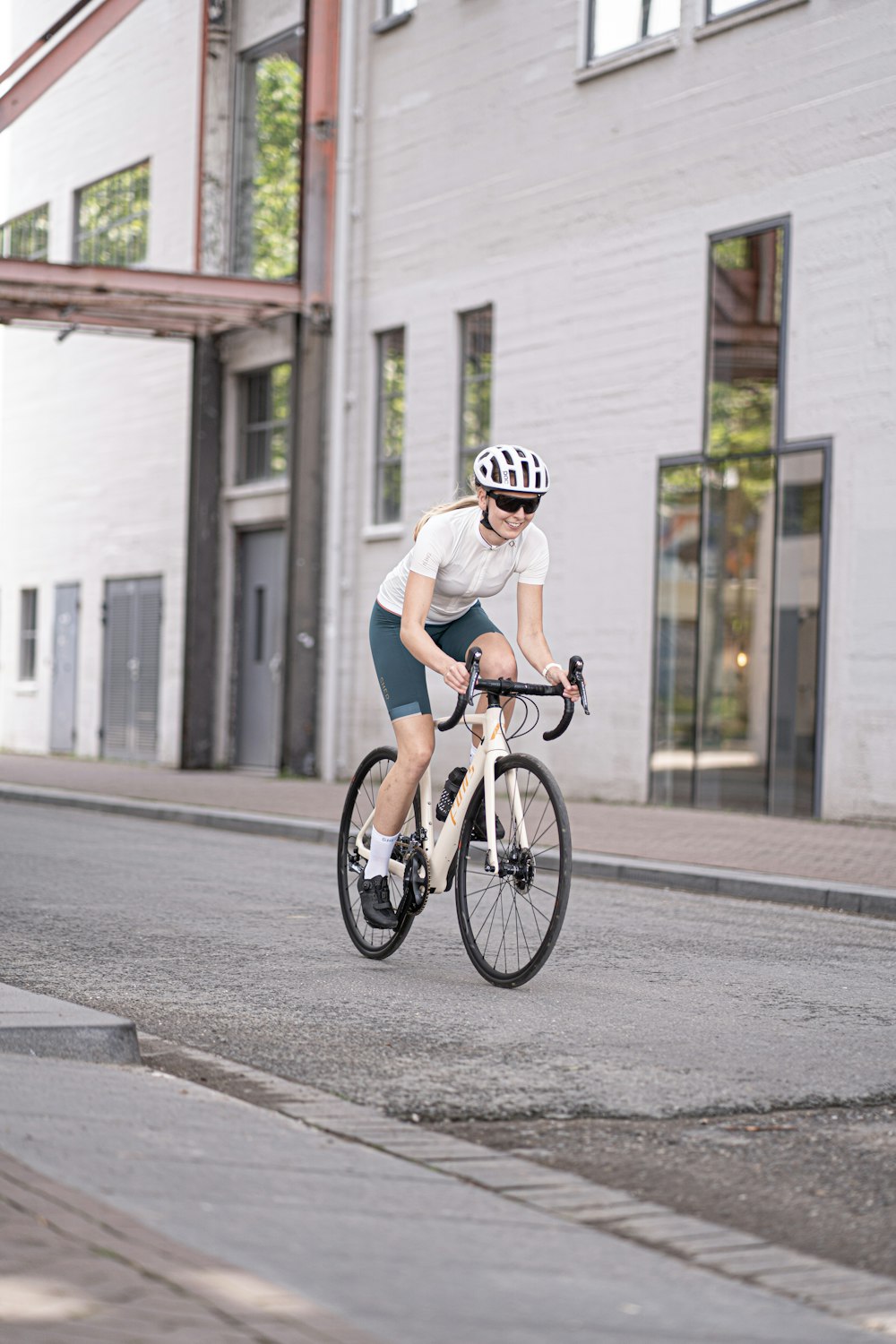 man in white t-shirt riding on bicycle during daytime