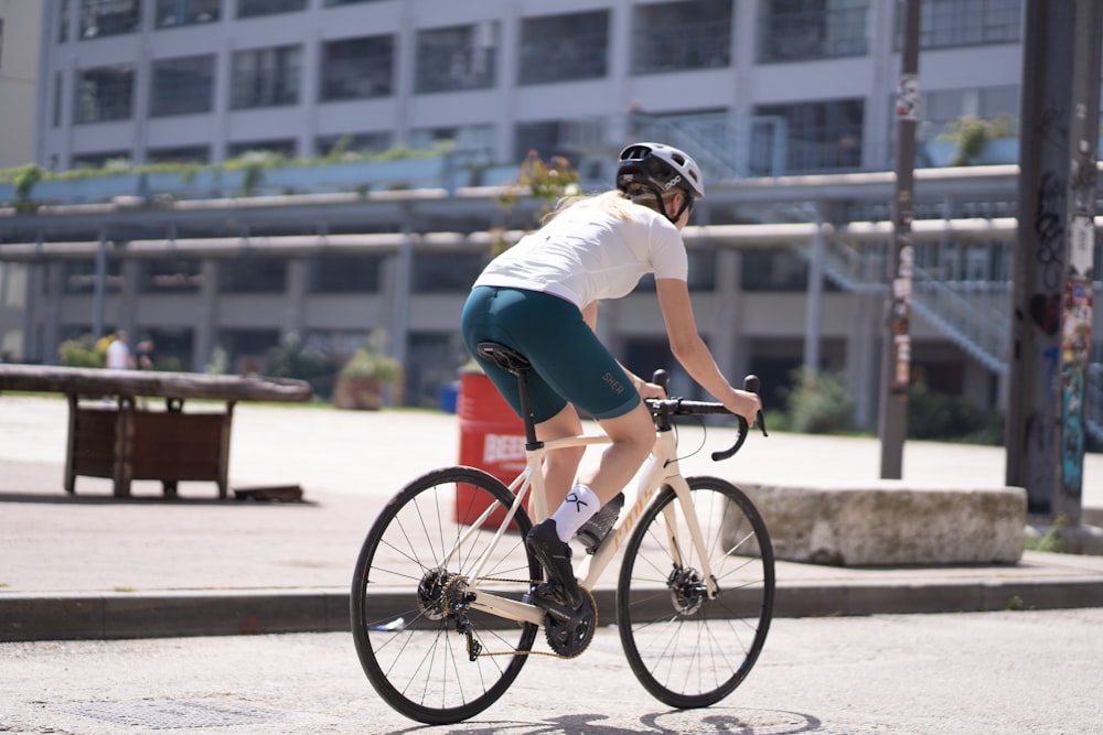 man in white t-shirt riding on bicycle during daytime