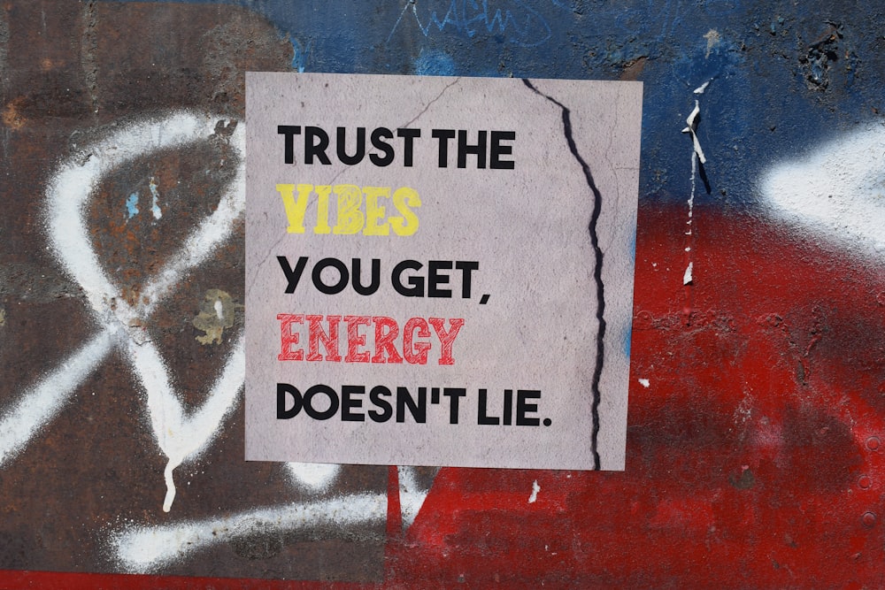 a sign on a wall that says trust the vibes you get energy doesn '