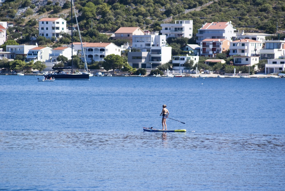 woman in pink dress riding on boat during daytime