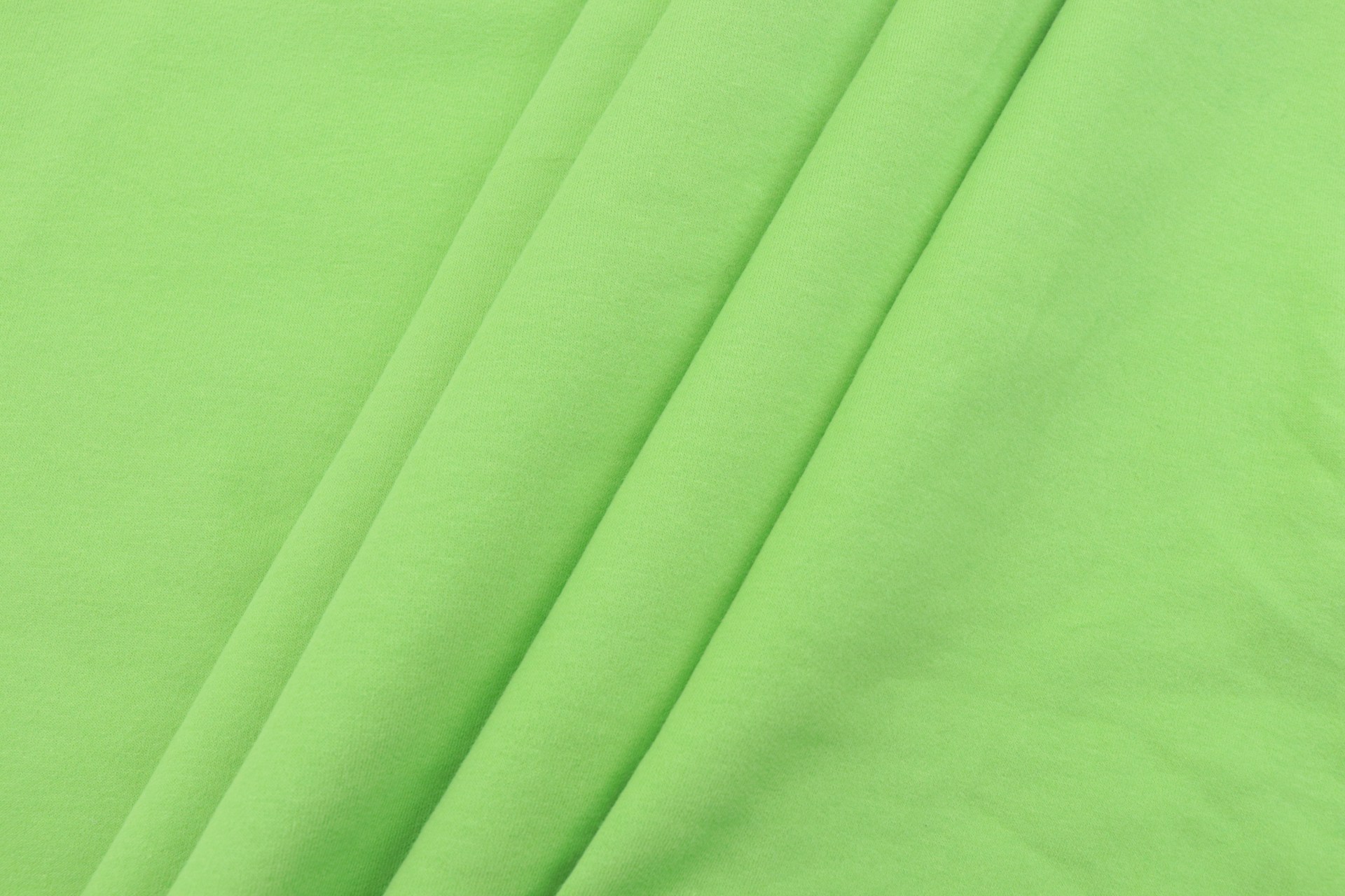 green textile on white textile