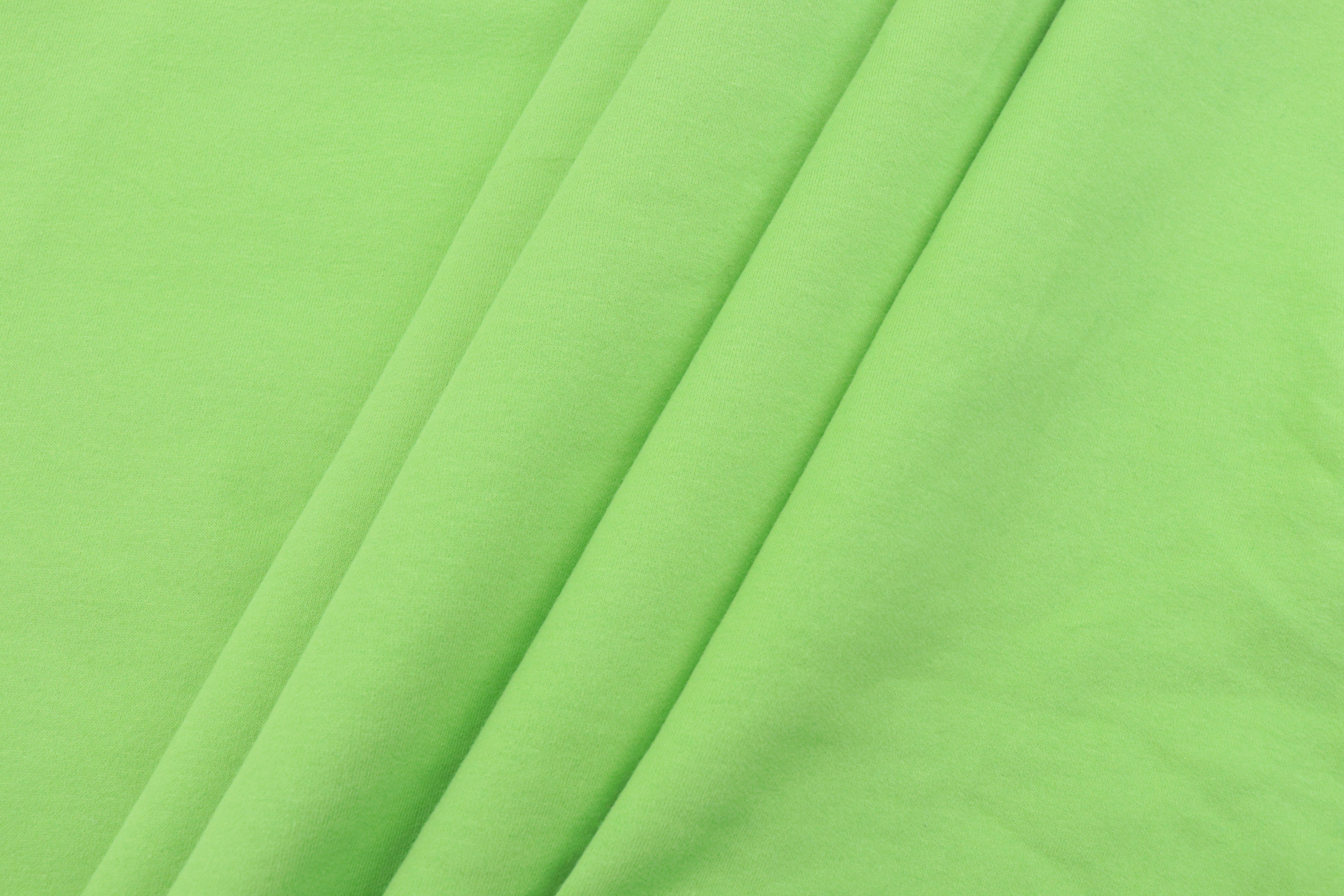 green textile on white textile