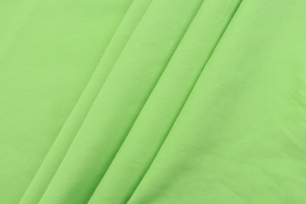 green textile on white textile