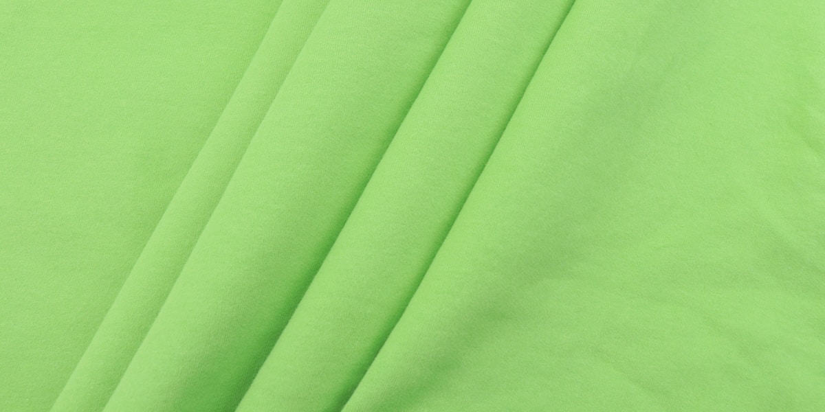 green textile on white textile