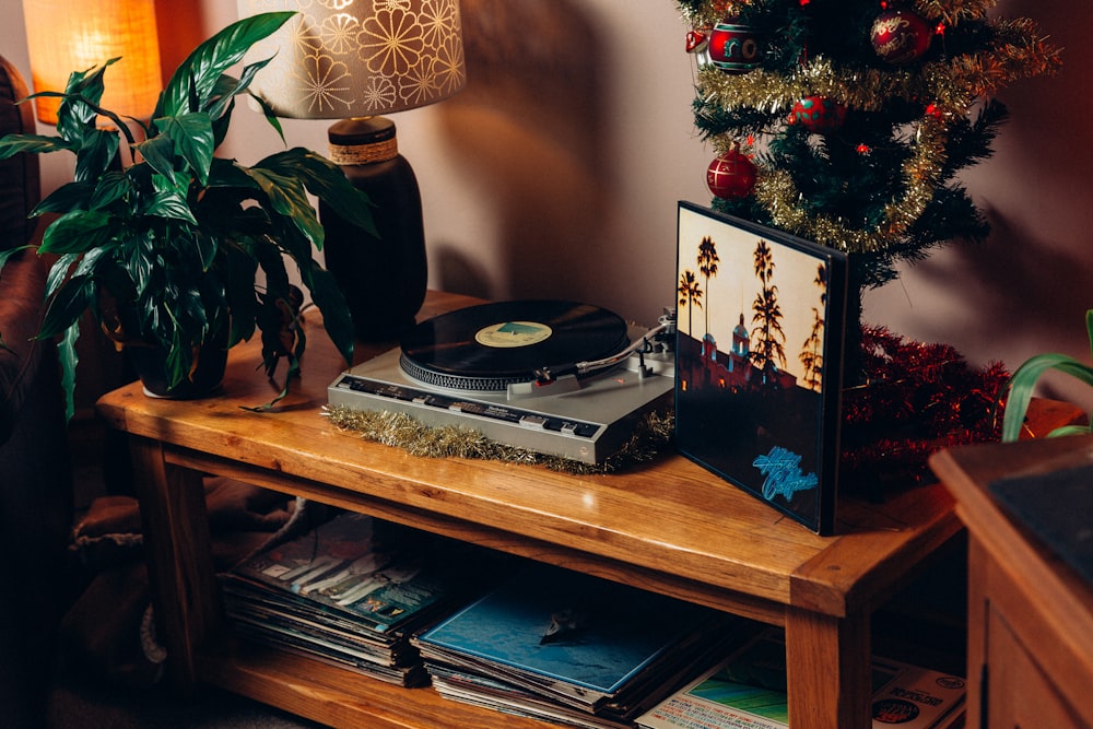 black and white vinyl record player on brown wooden table