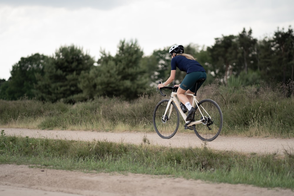 man in black t-shirt riding on bicycle during daytime