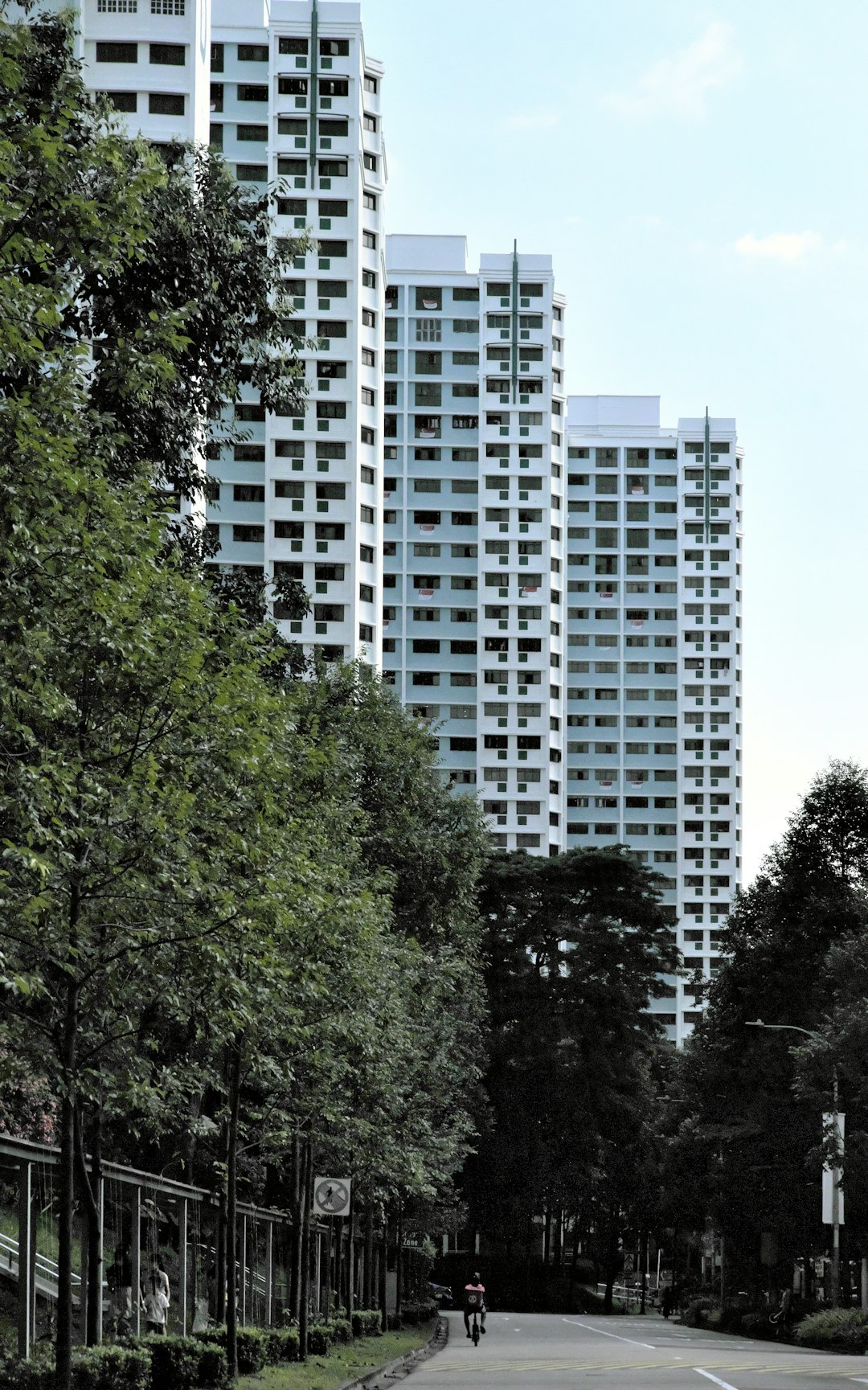 green trees near white concrete building during daytime