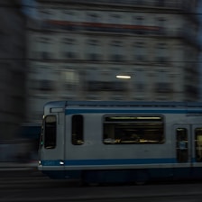 A sleek tram moving through a cityscape at dusk, highlighting modern transit.