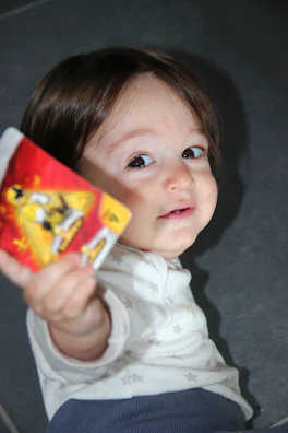 Smiling kids excitedly showing off their card finds to a parent.