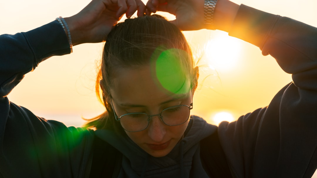 woman in black jacket wearing eyeglasses