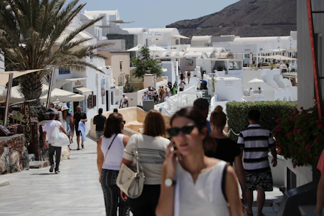 A vibrant coastal town street in Andalusia with locals enjoying a sunny afternoon.