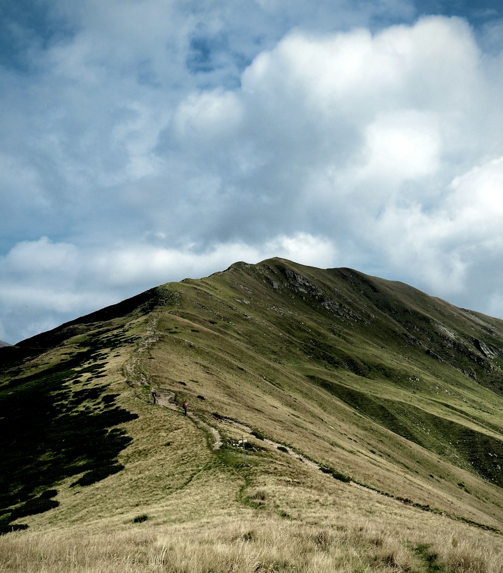 green mountain under white clouds during daytime