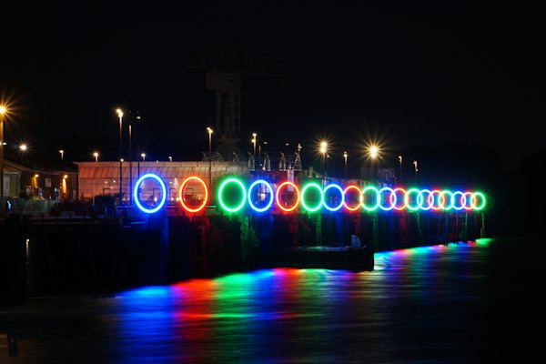 Rings of coloured light over the water at night — Nantes, France