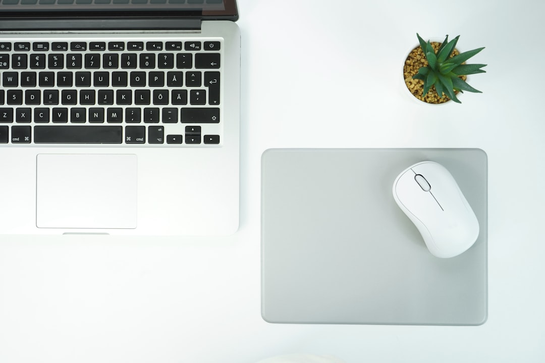 macbook pro beside apple magic mouse