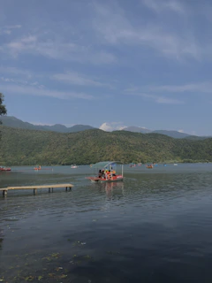 red and white boat on body of water during daytime