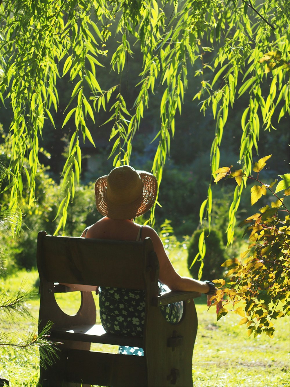 woman in brown sun hat sitting on black chair