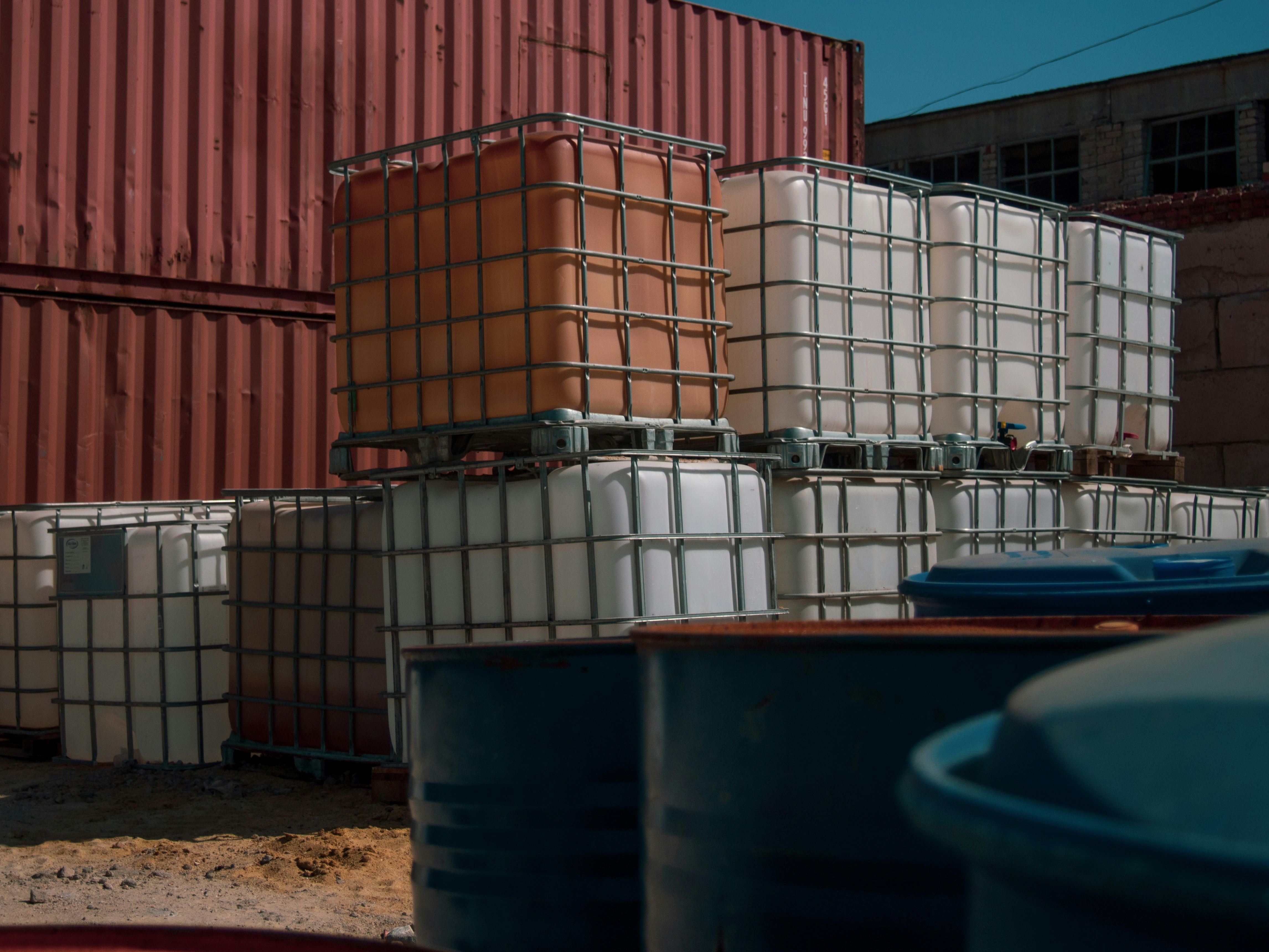 blue plastic bucket near brown and white container